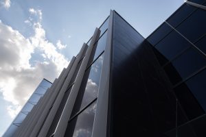 bottom-view-of-new-and-modern-building-with-glass-walls-reflecting-sky.jpg